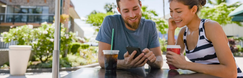 Two people looking at a phone smiling