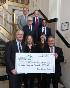 Bank Board of Directors hold big charitable check