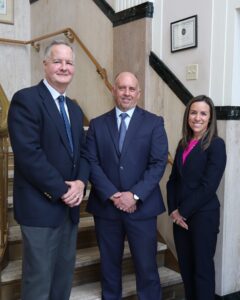 Donald Gibson, Keith DeMichele, & Megan Zahn standing in lobby