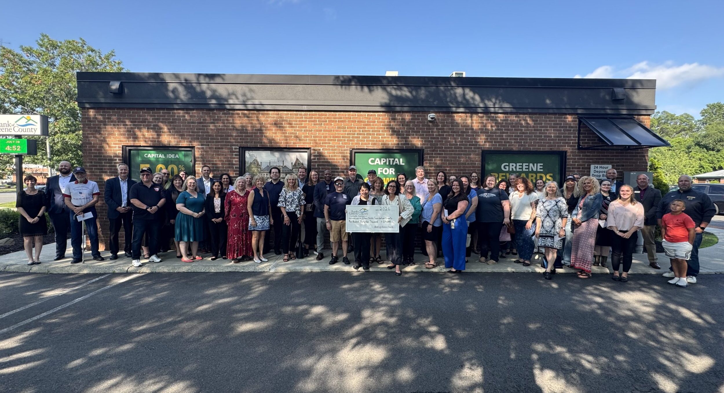 Wolf Road branch charitable ceremony group picture with big check