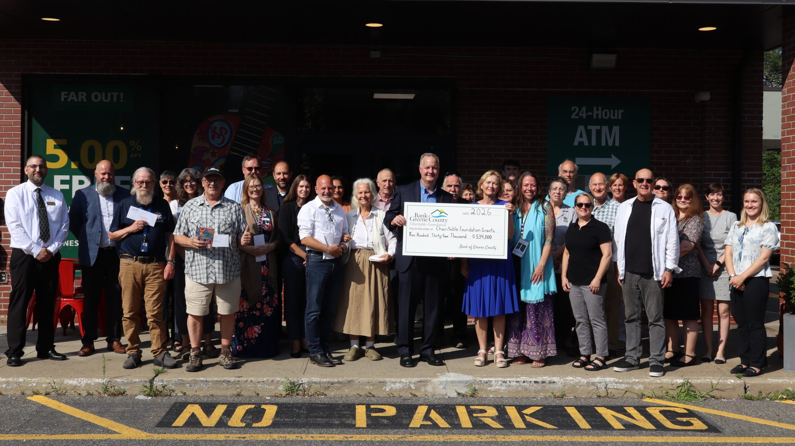 Woodstock branch charitable ceremony group picture with big check